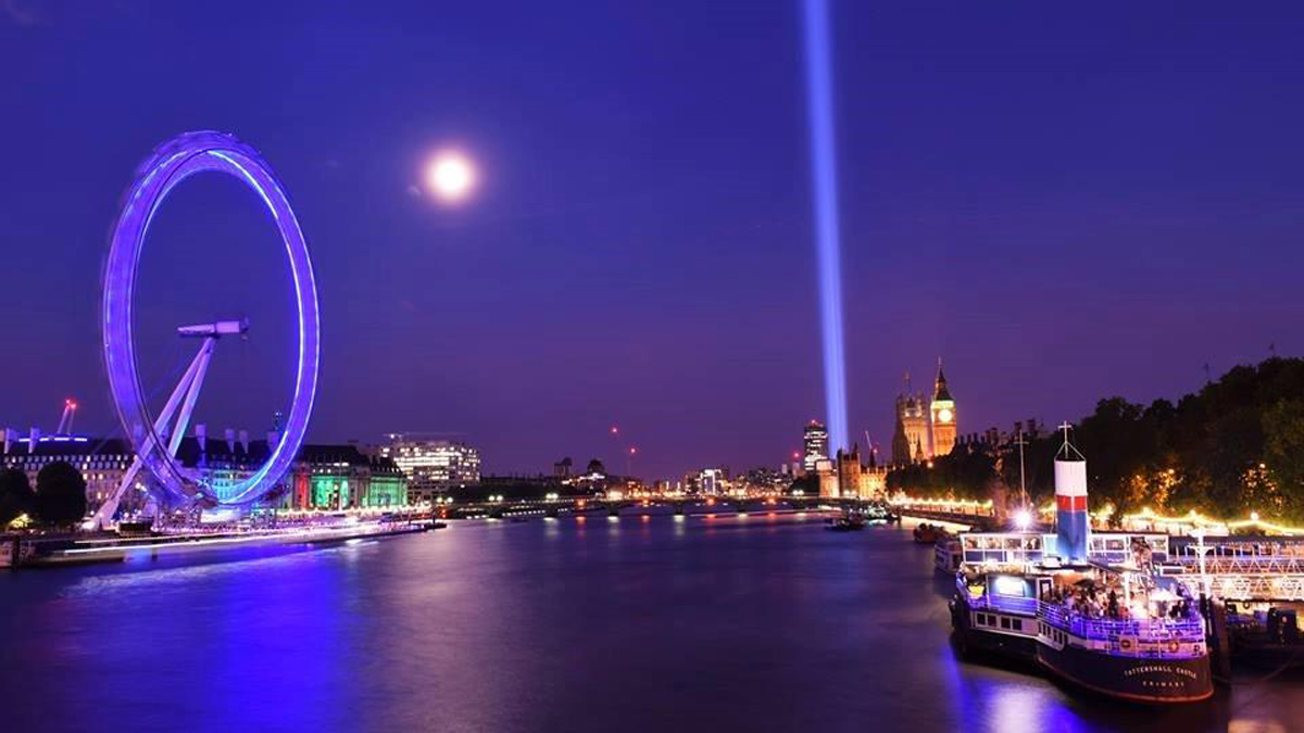 Photo of the boat on the Thames along with the London Eye, County Hall and Big Ben, all illuminated at night