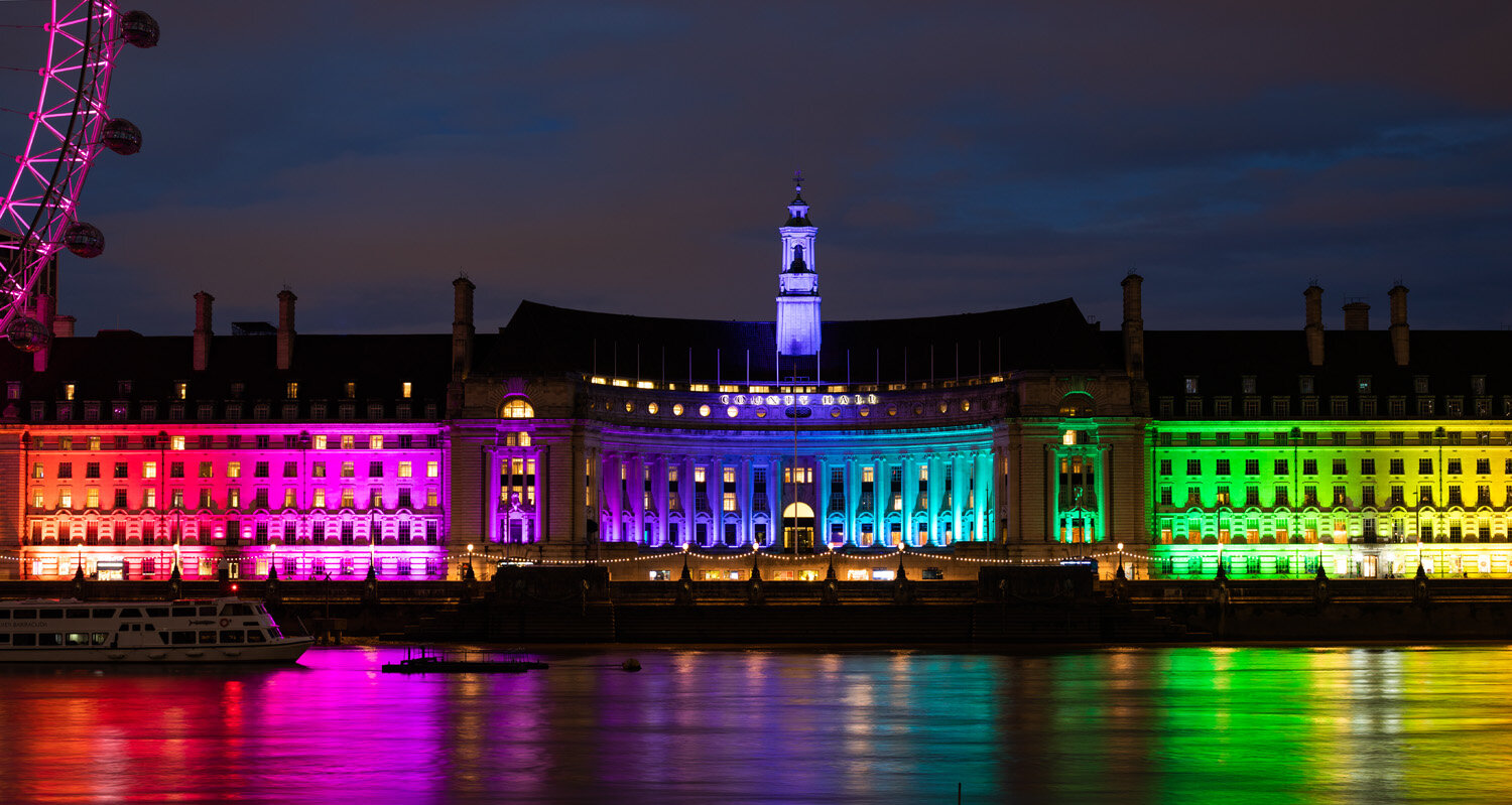Photo of a view of County Hall illuminated in rainbow colours